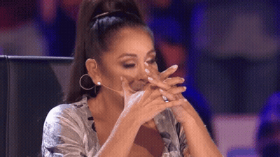 Woman Covering Face With Hands At Microphone GIF