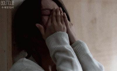 Woman Covering Face With Hands In Sweater GIF