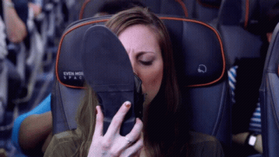 Woman Covering Face With Shoe On Airplane Seat Saying Even More Spac GIF