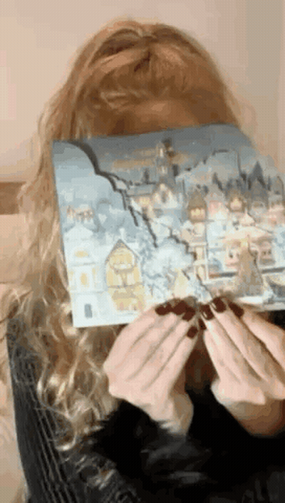 Woman Covering Face With Snowy City Painting GIF