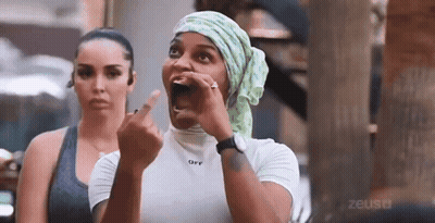 Woman Covering Head In Black Top GIF
