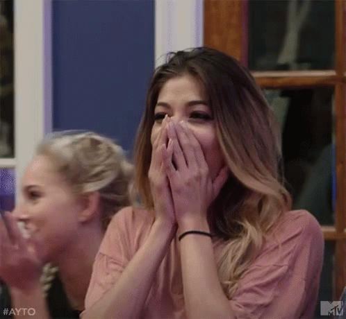Woman Covering Mouth At Table GIF