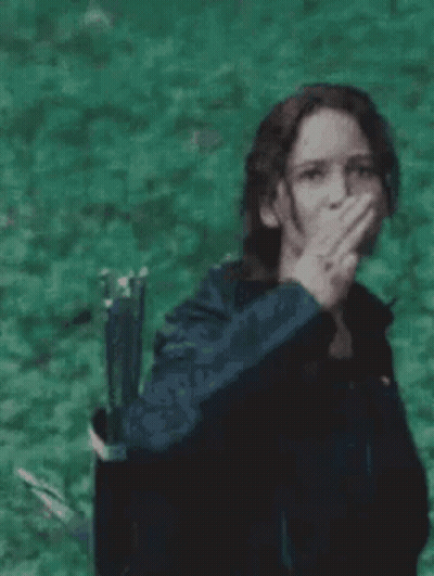 Woman Covering Mouth Holding Bow And Arrow GIF
