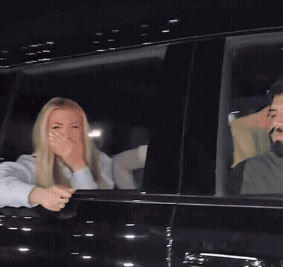 Woman Covering Mouth In Car GIF