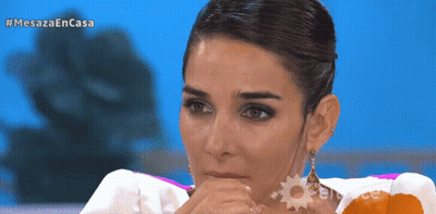 Woman Covering Mouth In Front Of Mesaza En Casa Screen GIF