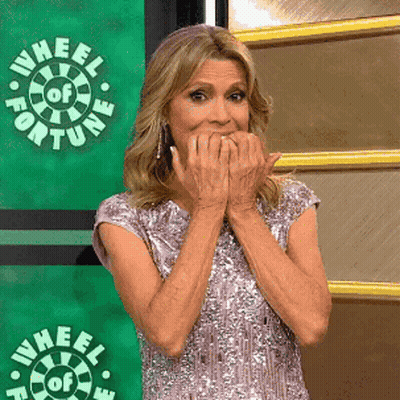 Woman Covering Mouth In Front Of Wheel Of Fortune Logo GIF