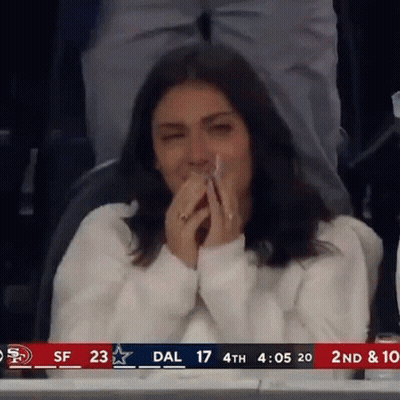 Woman Covering Mouth In Stadium GIF