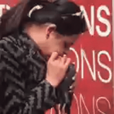 Woman Covering Mouth Near Red No Smoking Sign GIF