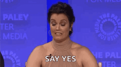 Woman Covering Nose And Smiling At Table GIF