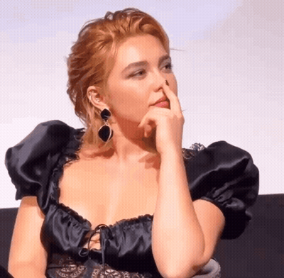 Woman Covering Nose In Black Dress GIF