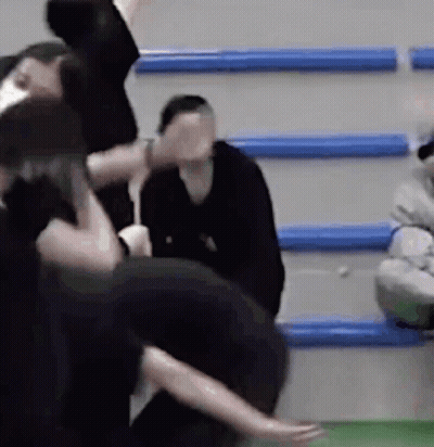 Woman Covers Face, Group Dances In Gym GIF