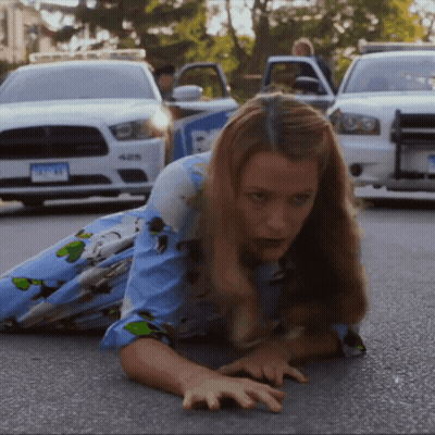 Woman Crawling In Front Of Police Car GIF
