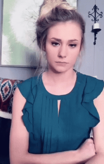Woman Crossed Arms Wearing Teal Top GIF