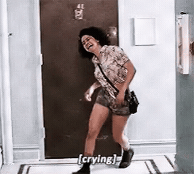 Woman Crying And Laughing In Hallway GIF