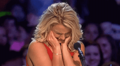 Woman Crying At Microphone In Front Of Crowd GIF