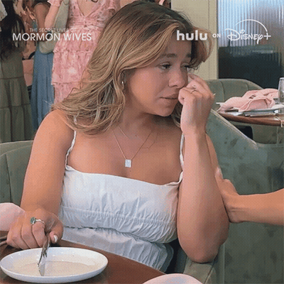 Woman Crying At Table With Food And Hulu Logo GIF