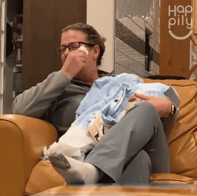 Woman Crying Holding Baby In Front Of Hap Pilu Sign GIF