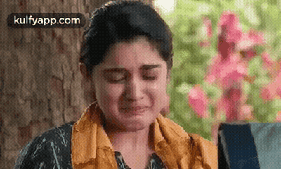 Woman Crying In Front Of Tree And Flowers GIF