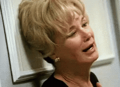 Woman Crying Leaning Against Wall GIF