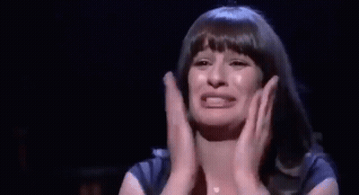 Woman Crying On Stage With Hands Folded GIF