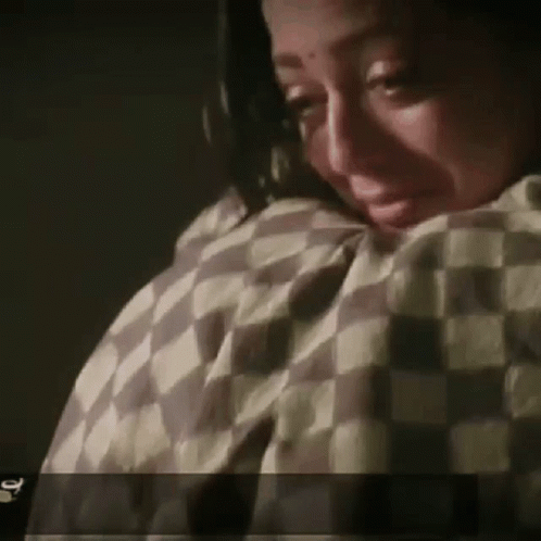 Woman Crying With Checkered Blanket GIF