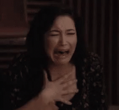 Woman Crying With Hands On Chest Making Funny Face GIF