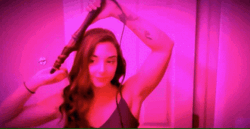 Woman Curling Her Hair Ready To Party GIF