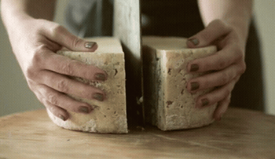 Woman Cutting Cheese In Half GIF