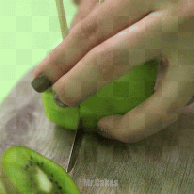 Woman Cutting Kiwi With Knife Mr. Cakes GIF