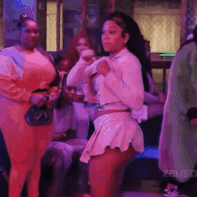 Woman Dancing In Club With Group Around Her GIF