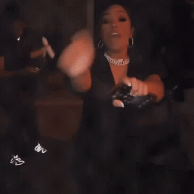 Woman Dancing In Dark Room Holding Cell Phone GIF