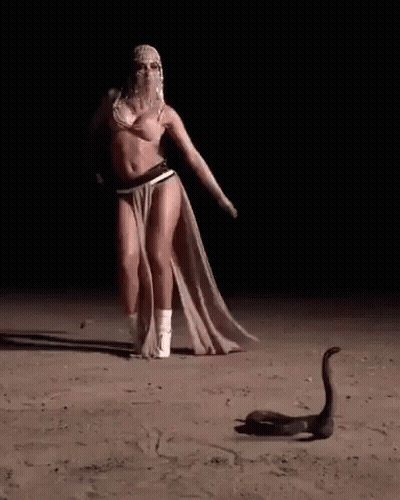 Woman Dancing In Desert At Night With Snake GIF