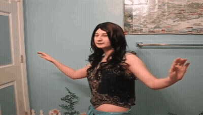 Woman Dancing In Front Of Blue Wall GIF