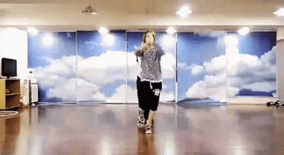 Woman Dancing In Front Of Cloud Wall GIF