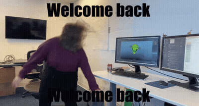 Woman Dancing In Front Of Computer Monitors Saying Welcome Back GIF