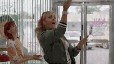 Woman Dancing In Front Of Glass Door GIF