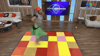 Woman Dancing In Front Of Gran Hermano TV Screen GIF