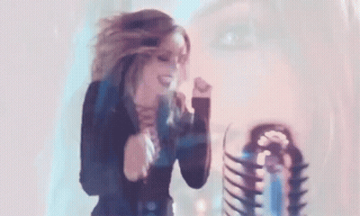 Woman Dancing In Front Of Microphone With Skeleton In Background GIF