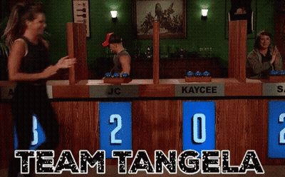 Woman Dancing In Front Of Team Tangela Scoreboard GIF