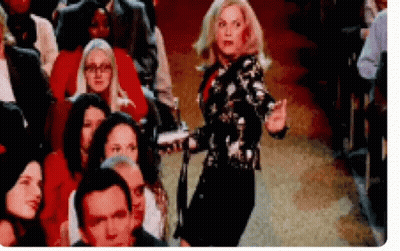 Woman Dancing in Front of Theater Crowd