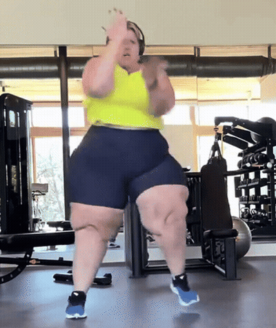 Woman Dancing In Gym Wearing Shorts And Yellow Tank Top GIF