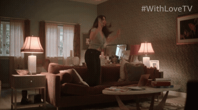 Woman Dancing In Living Room With #WithLoveTV On Wall GIF