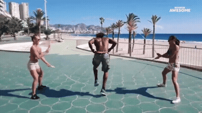 Woman Dancing In Park, Man Holding Drink GIF