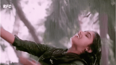 Woman Dancing In Rain With Arms Outstretched Smiling GIF