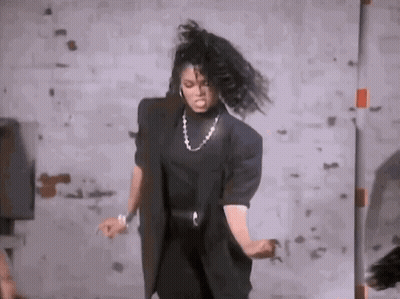 Woman Dancing In Room With Brick Wall GIF