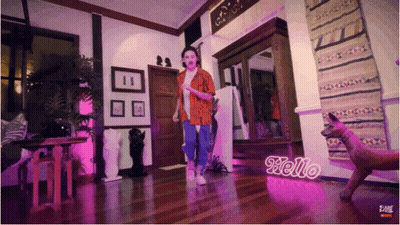 Woman Dancing In Room With Hello Sign GIF