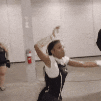 Woman Dancing In Room With Red Fire Extinguisher GIF