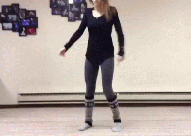 Woman Dancing In Studio Wearing Black Shirt And Jeans GIF