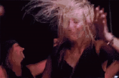 Woman Dancing In Windy Crowd GIF