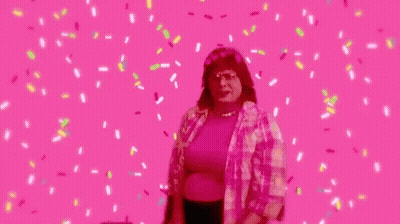 Woman Dancing On Pink Background With Confetti GIF